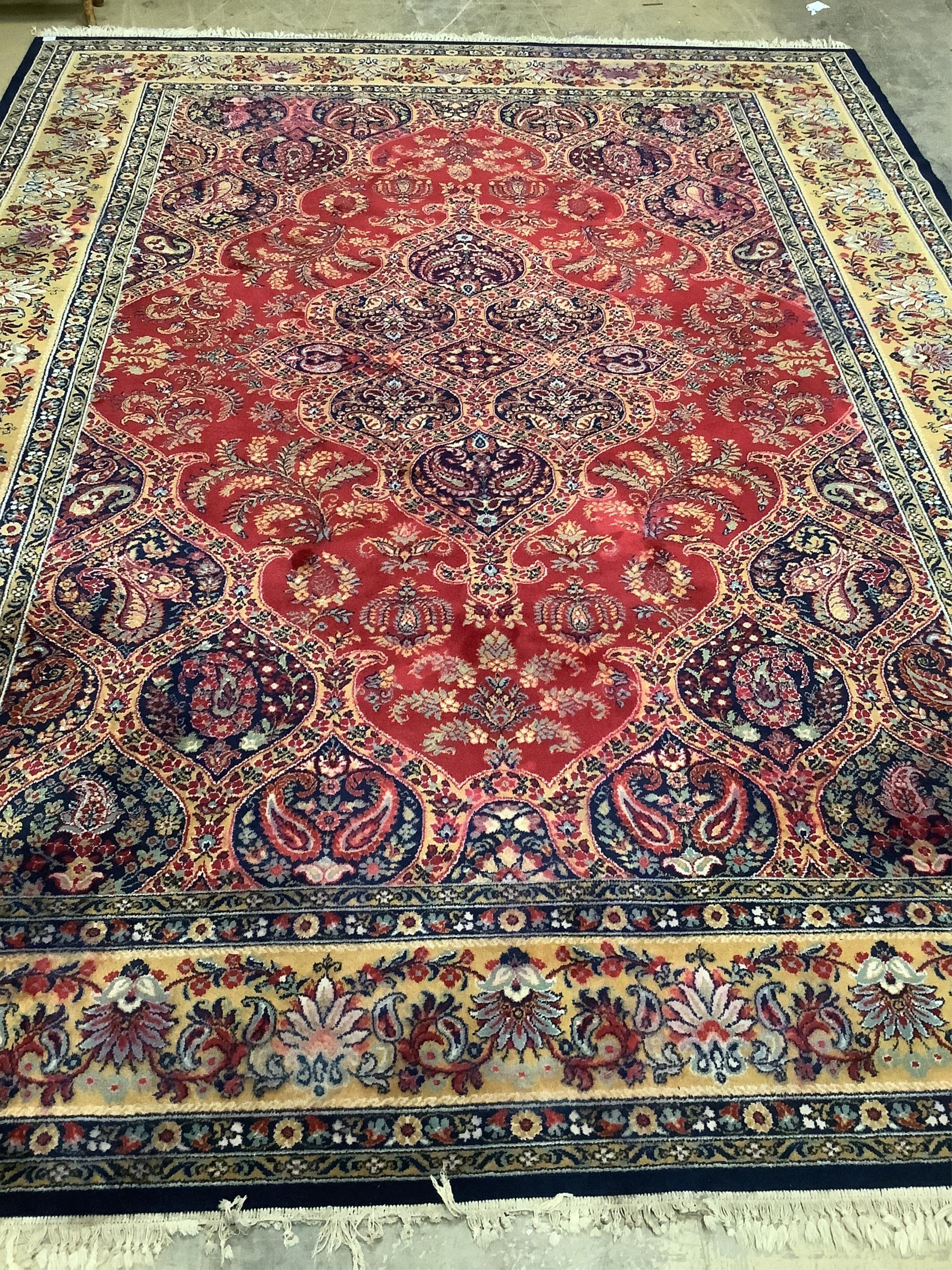 A Kashmiri style red ground carpet, 360 x 270cm. Condition - good